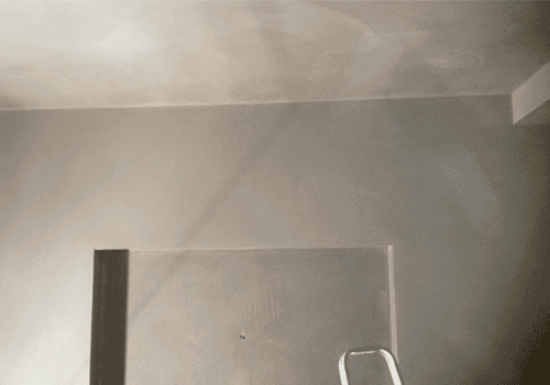 A newly plastered wall and ceiling face.