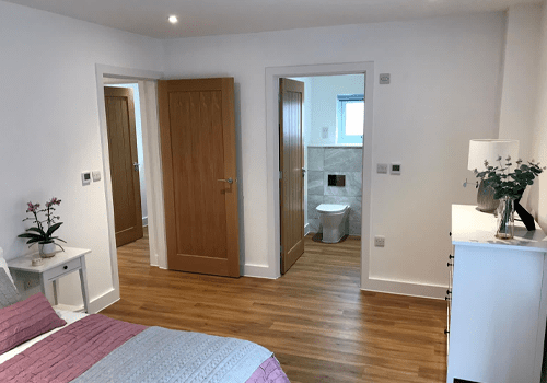 Interior of a bedroom with an en suite bathroom.